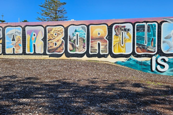 Mural with 'Scarborough is OK!' in bold letters, featuring vibrant beach-themed imagery.